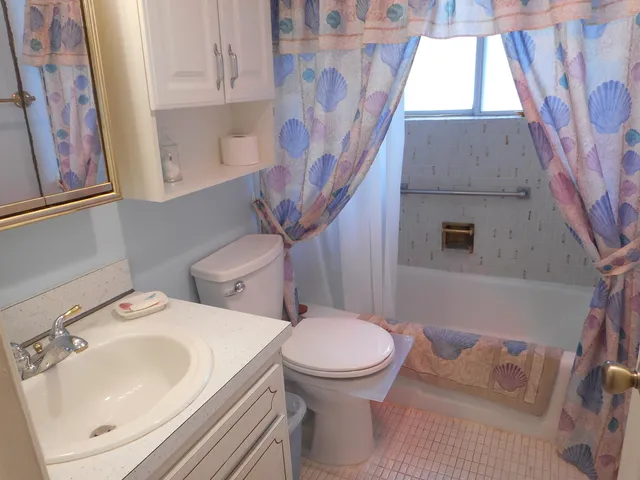 a bed sitting in a bedroom next to a window and dresser