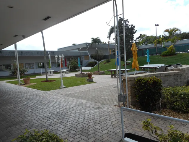 a room with furniture pool table and windows