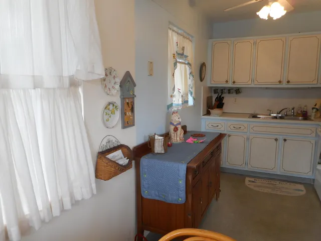 a kitchen with cabinets a sink and appliances