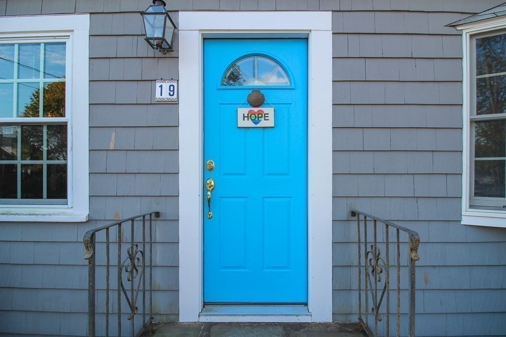 a view of front door with wooden door