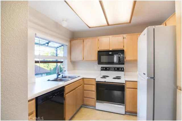 a kitchen with stainless steel appliances a stove sink and microwave