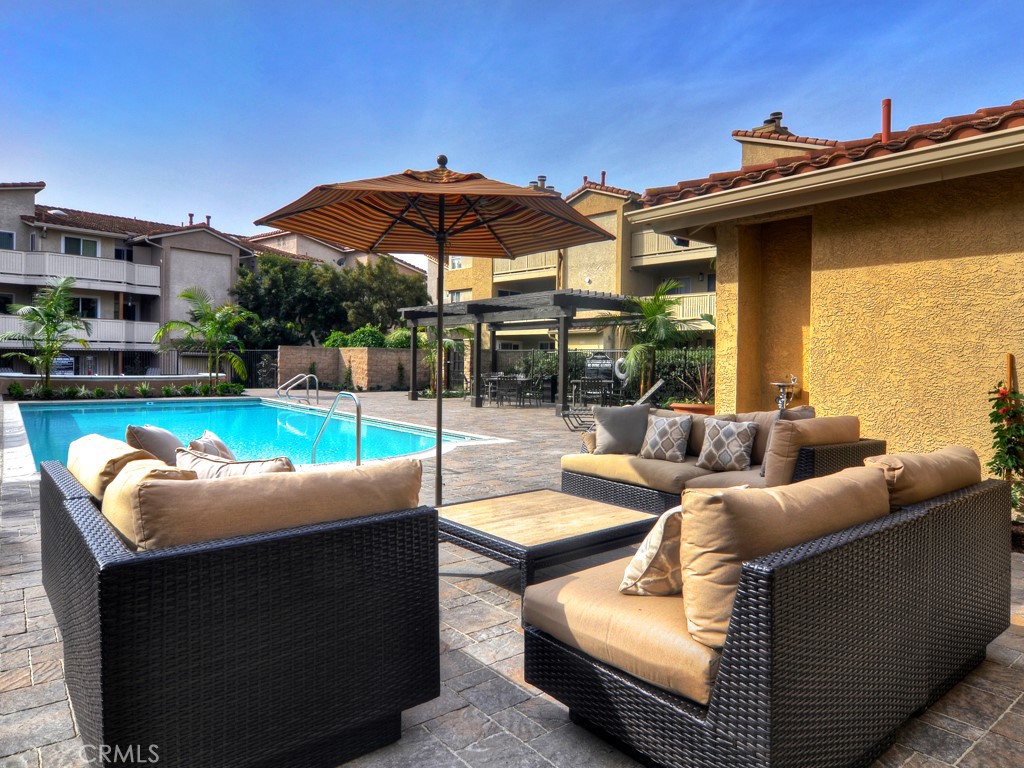 18 Corniche Drive, Unit E Dana Point, CA 92629 - Photo 20 of 38 a view of a patio with couches chairs and a umbrella