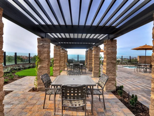 a view of a patio with a table chairs and a backyard