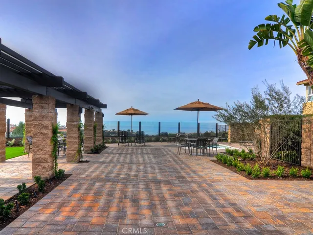 a view of a chairs and table under an umbrella in patio