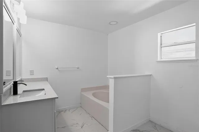 a bathroom with a granite countertop toilet a sink and mirror