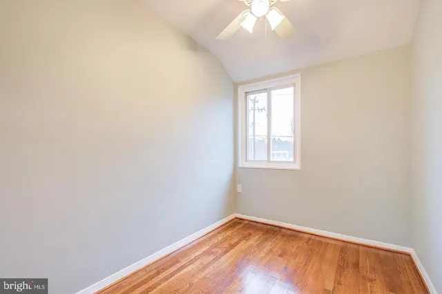a view of a room with wooden floor and a bathroom