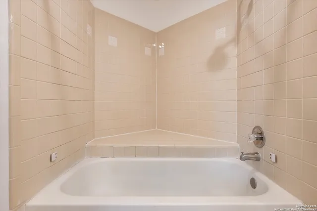 a bathroom with a granite countertop sink a toilet and a mirror