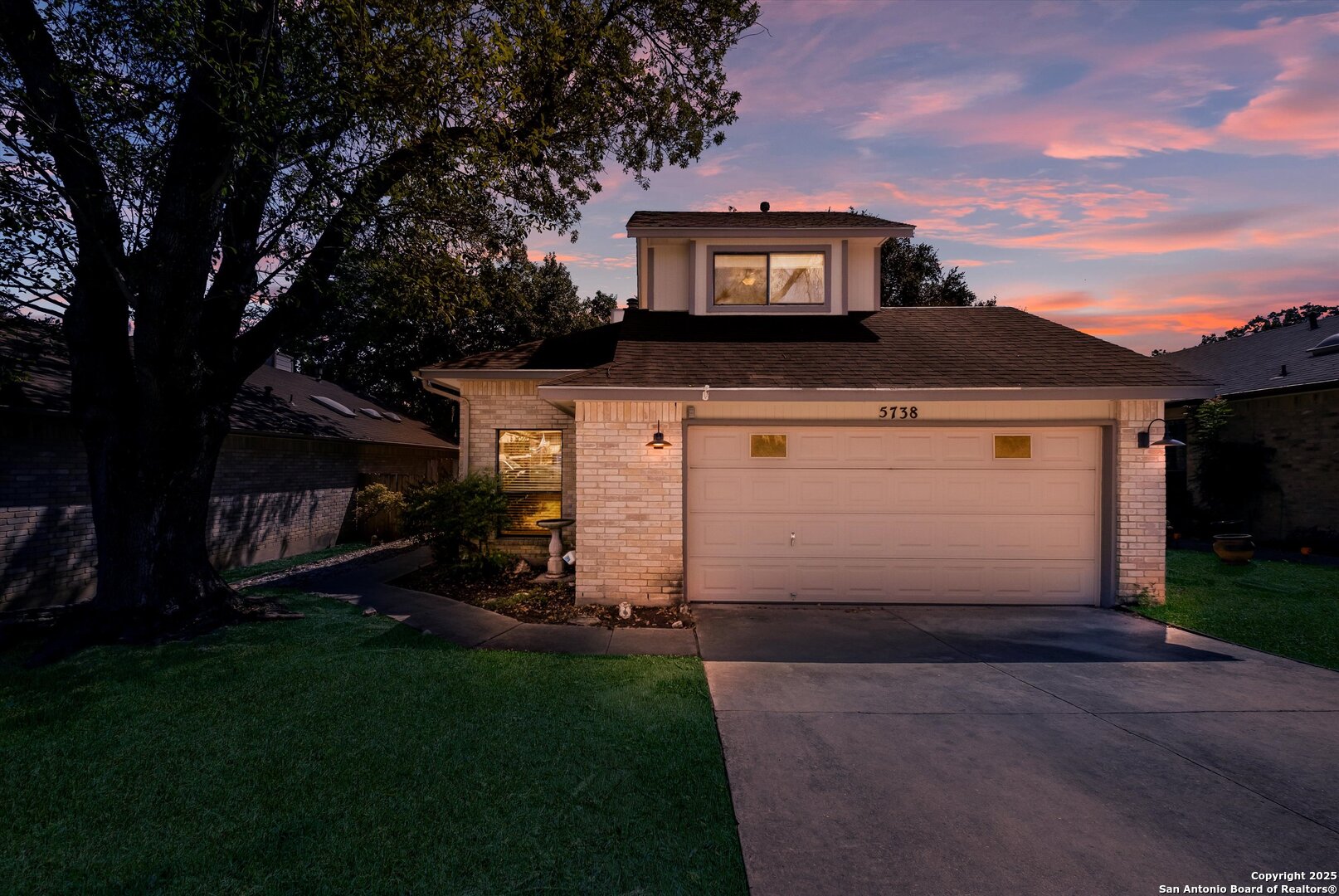 5738 Spring Sunshine San Antonio, TX 78247 - Photo 2 of 22 a front view of a house with a garden