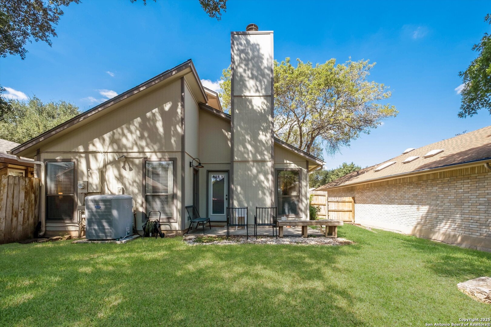 5738 Spring Sunshine San Antonio, TX 78247 - Photo 21 of 22 a view of a house with a big yard and large tree