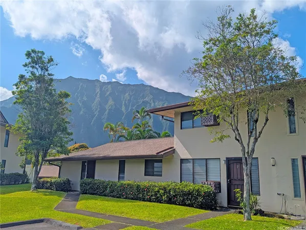 a front view of a house with garden
