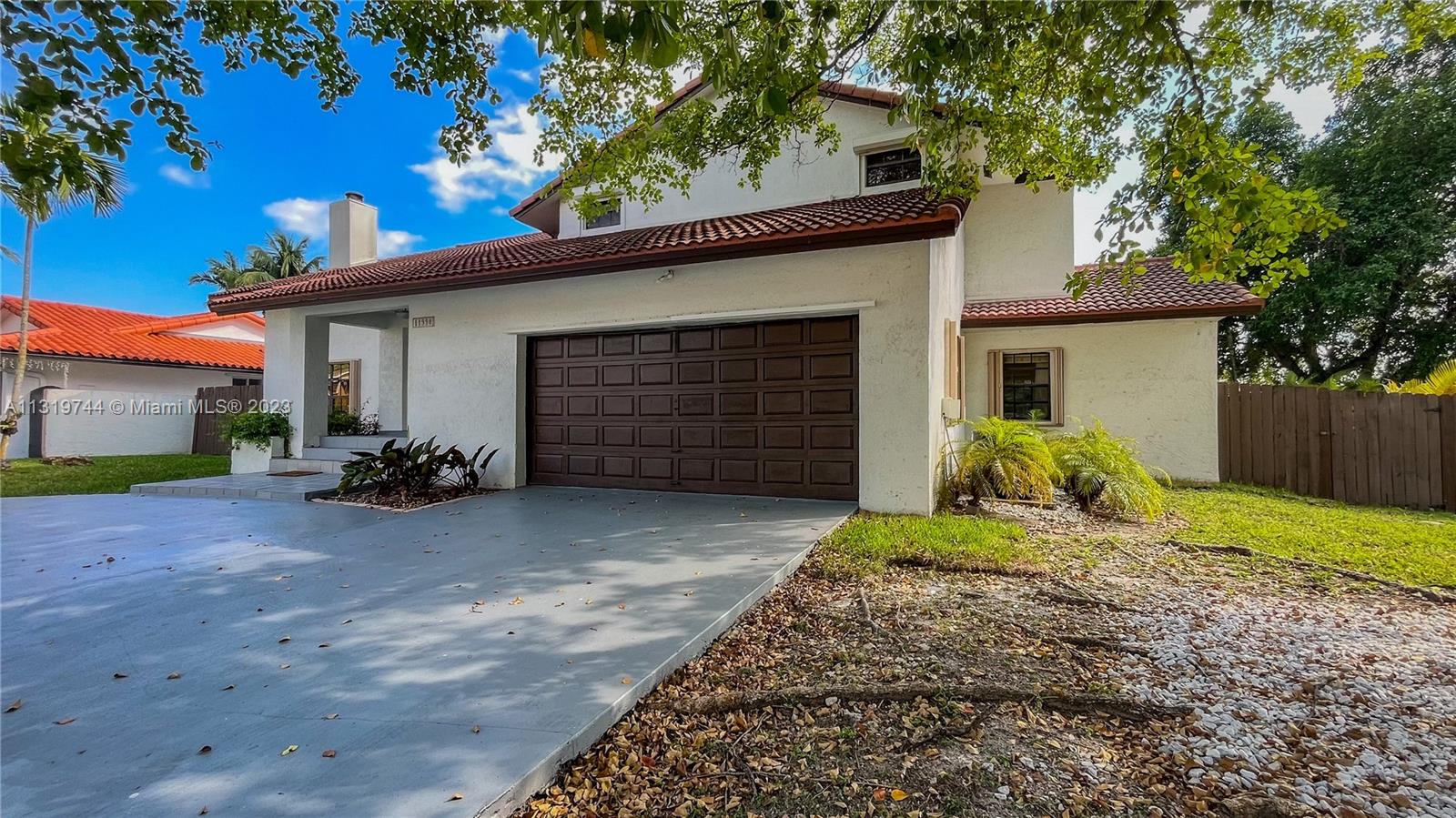 11990 Southwest 92nd Street Miami, FL 33186 - Photo 1 of 33 a front view of a house with a yard