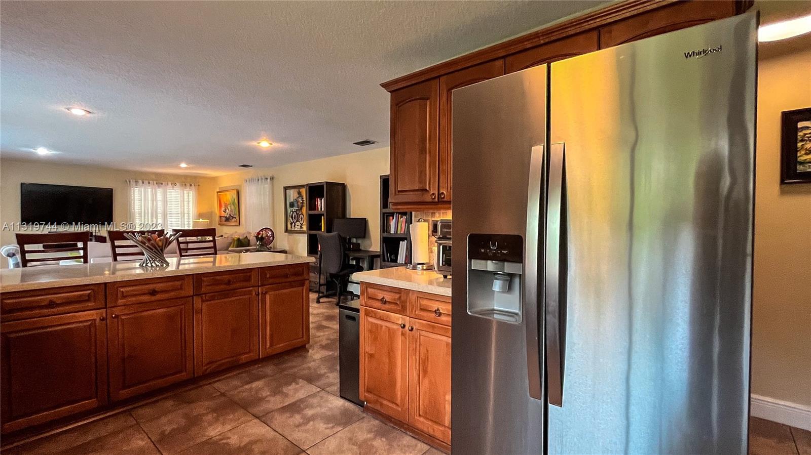 11990 Southwest 92nd Street Miami, FL 33186 - Photo 11 of 33 a kitchen with stainless steel appliances granite countertop a refrigerator and a stove top oven
