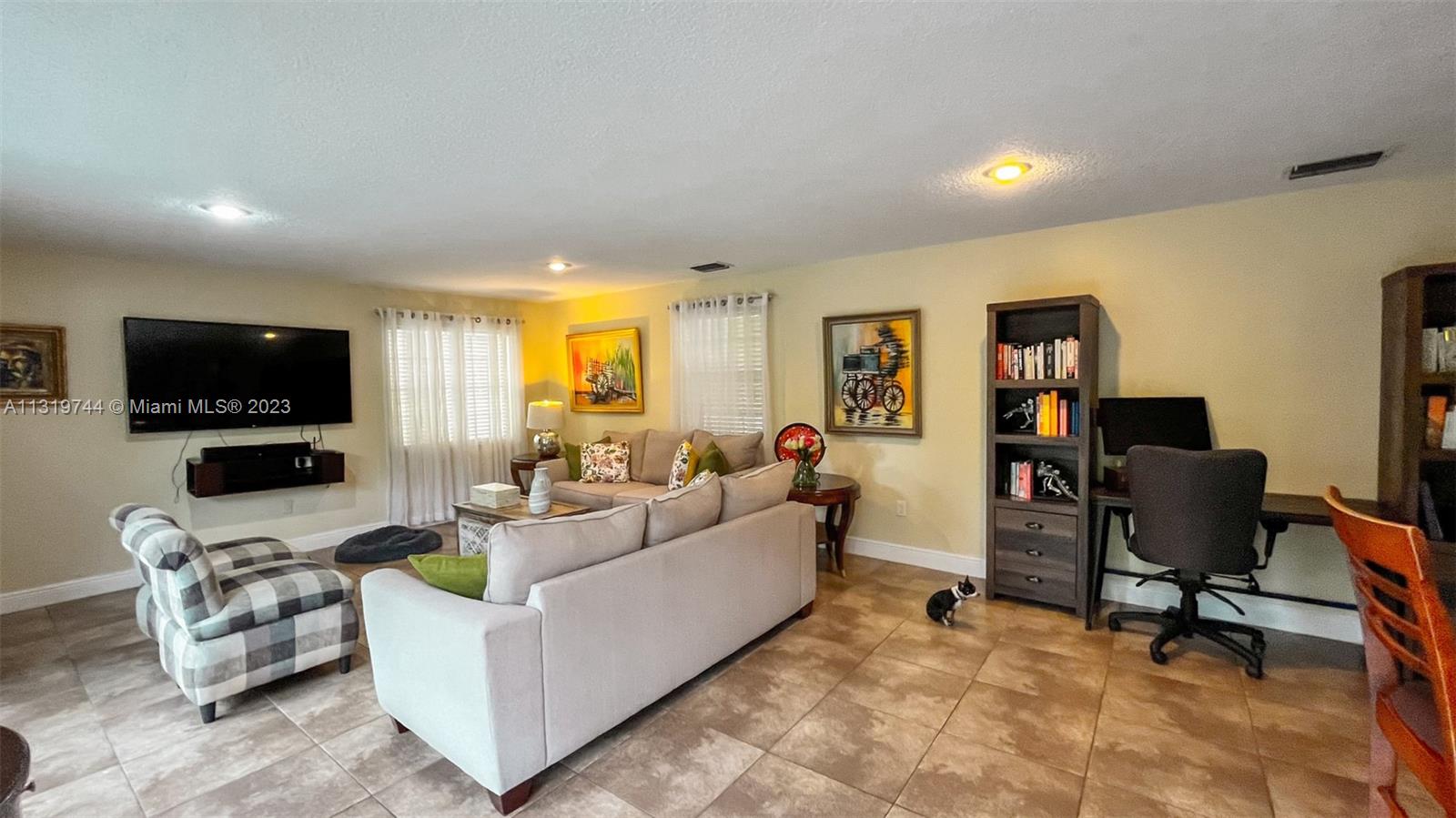 11990 Southwest 92nd Street Miami, FL 33186 - Photo 13 of 33 a living room with furniture and a flat screen tv