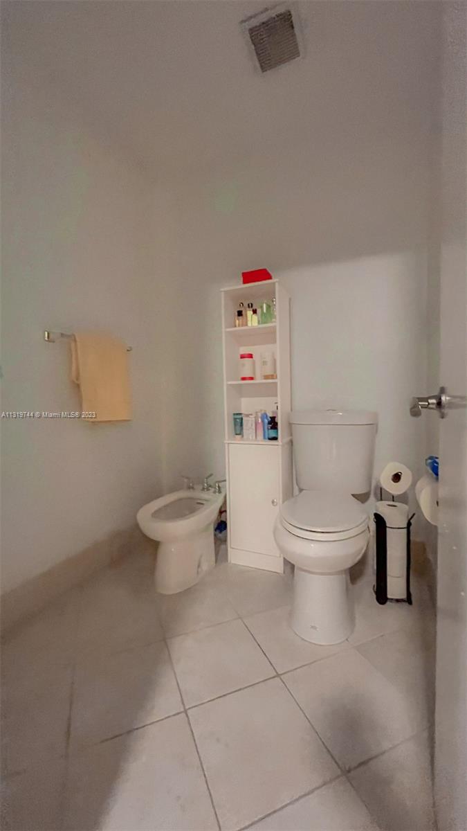 11990 Southwest 92nd Street Miami, FL 33186 - Photo 16 of 33 a white toilet sitting next to a bathroom sink and a toilet