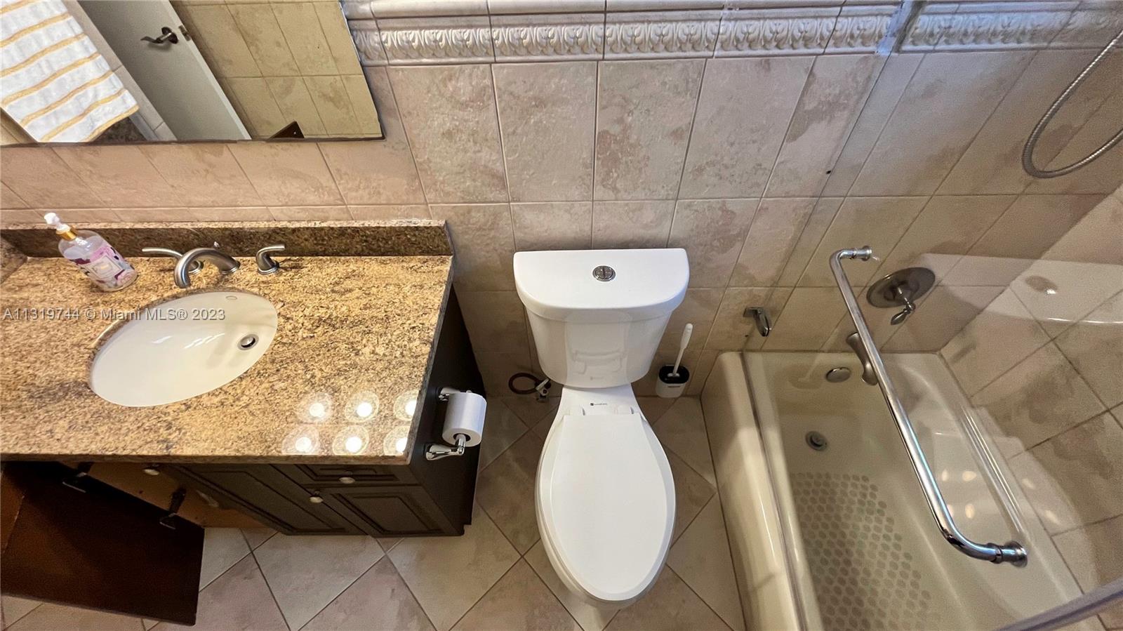 11990 Southwest 92nd Street Miami, FL 33186 - Photo 20 of 33 a bathroom with a granite countertop sink and a mirror