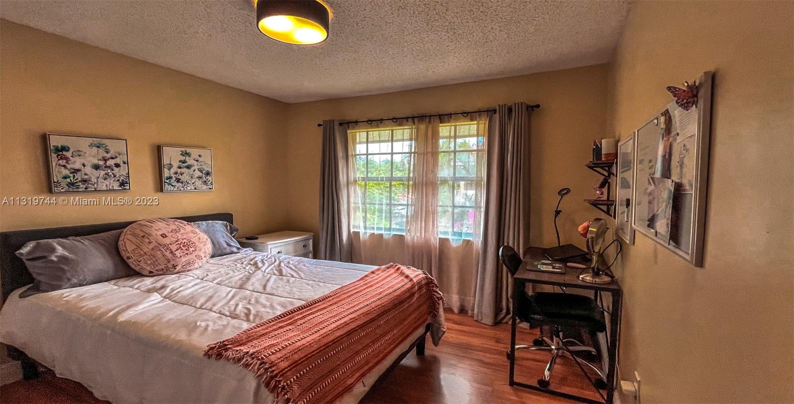 11990 Southwest 92nd Street Miami, FL 33186 - Photo 22 of 33 a bedroom with a bed and a window