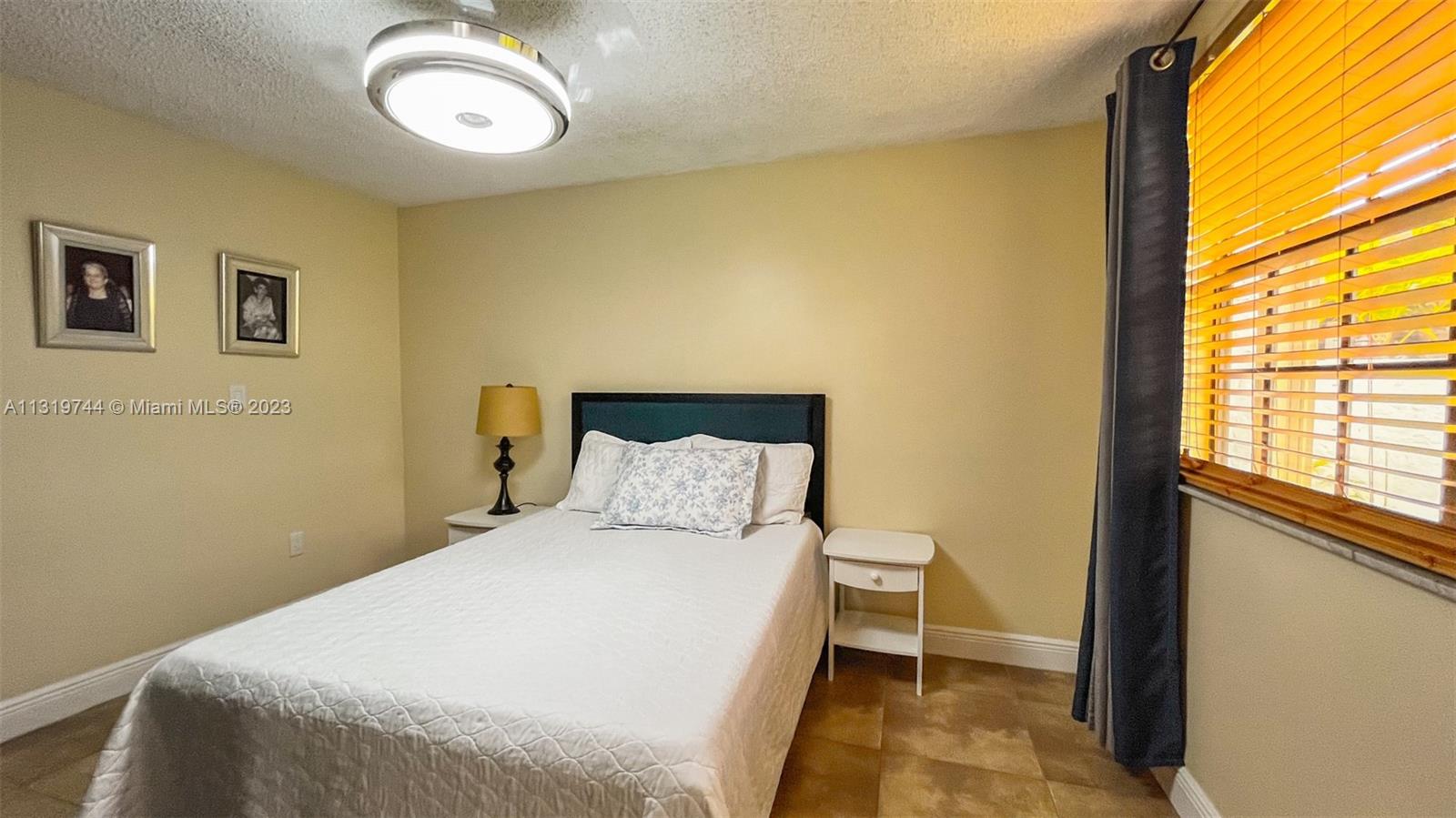 11990 Southwest 92nd Street Miami, FL 33186 - Photo 23 of 33 a bedroom with a bed and a window