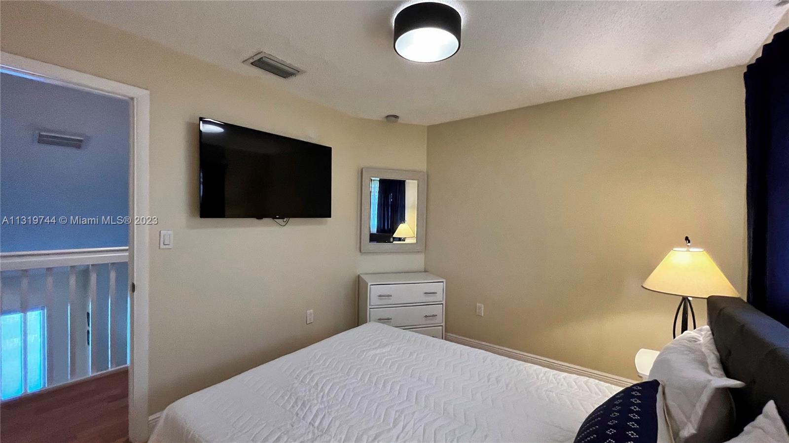 11990 Southwest 92nd Street Miami, FL 33186 - Photo 25 of 33 a bedroom with a bed and a flat screen tv