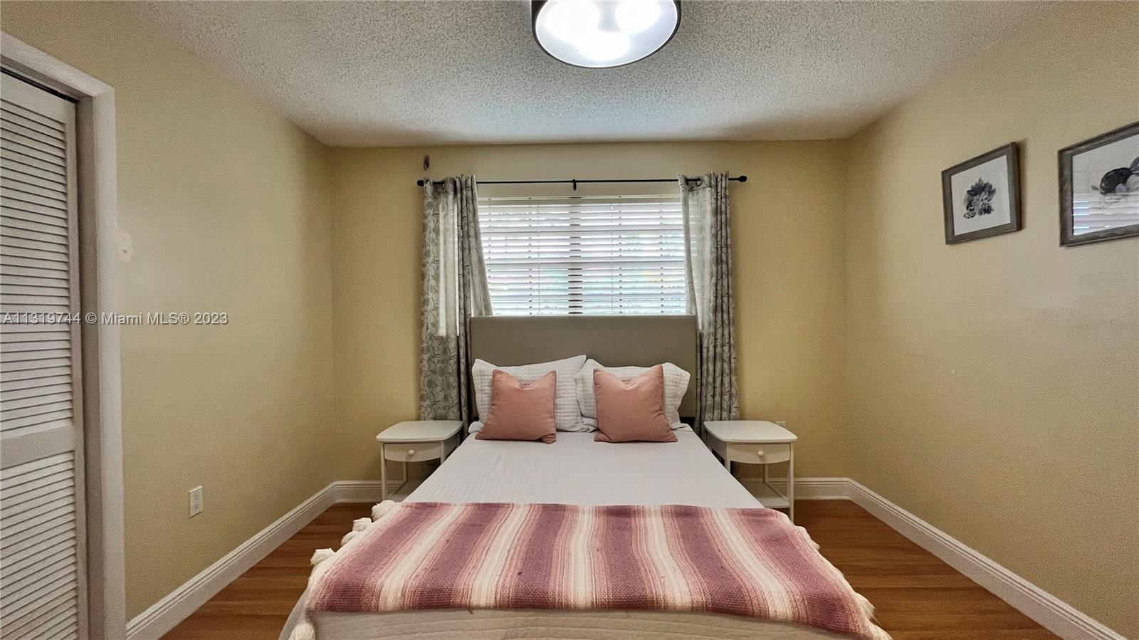 11990 Southwest 92nd Street Miami, FL 33186 - Photo 26 of 33 a bedroom with a bed and window
