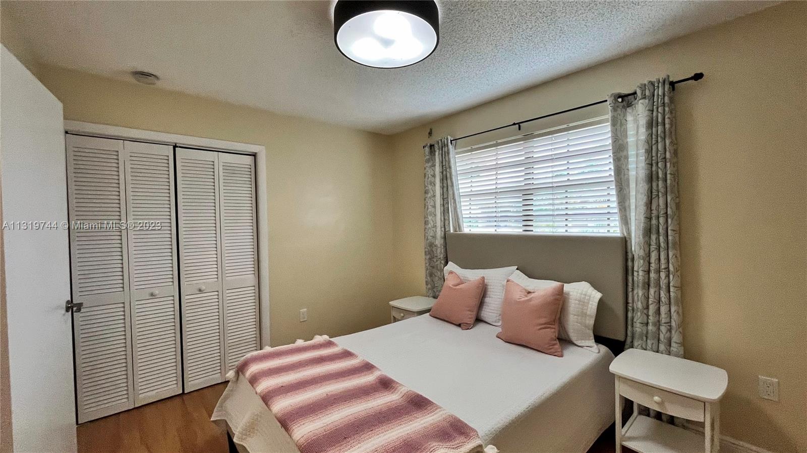 11990 Southwest 92nd Street Miami, FL 33186 - Photo 27 of 33 a bedroom with a bed and a chair