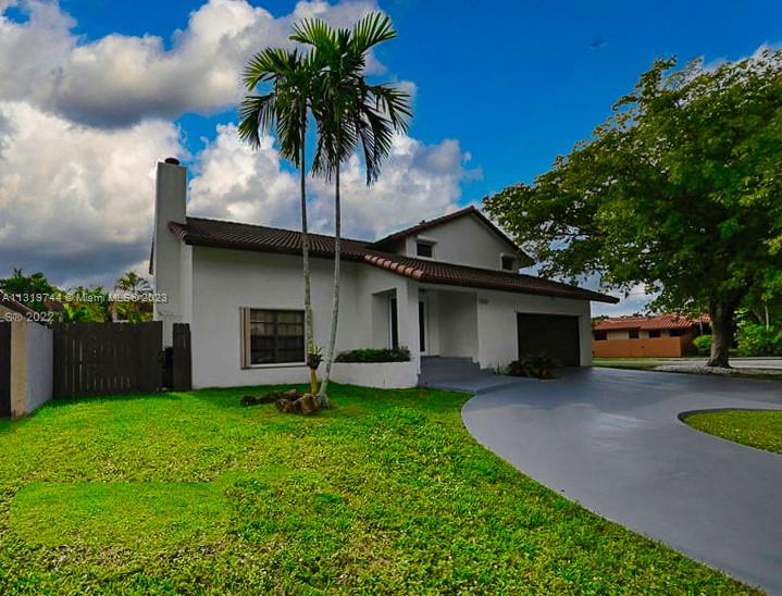 11990 Southwest 92nd Street Miami, FL 33186 - Photo 4 of 33 a front view of a house with garden