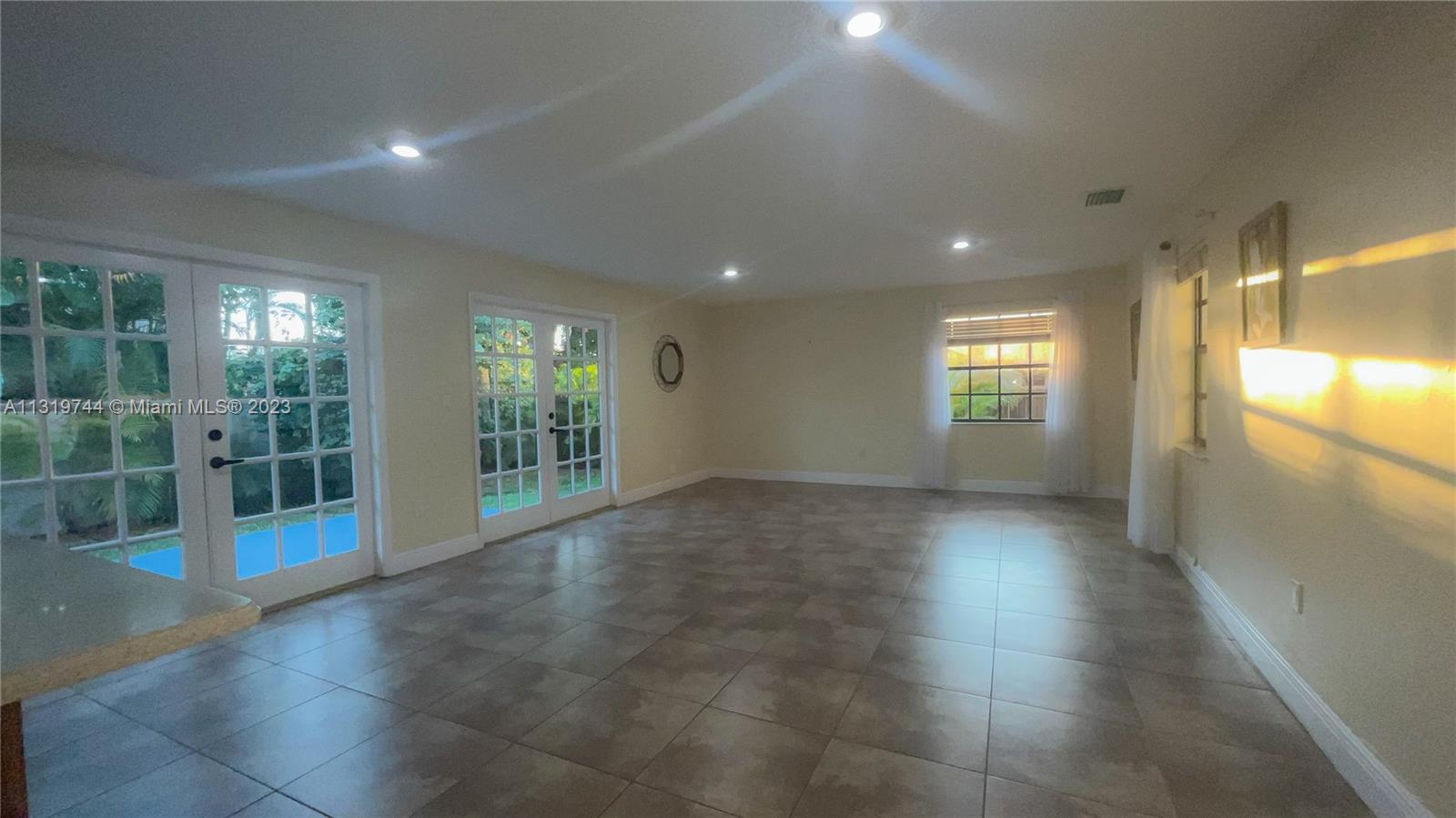 11990 Southwest 92nd Street Miami, FL 33186 - Photo 5 of 33 a view of an empty room with glass door and windows