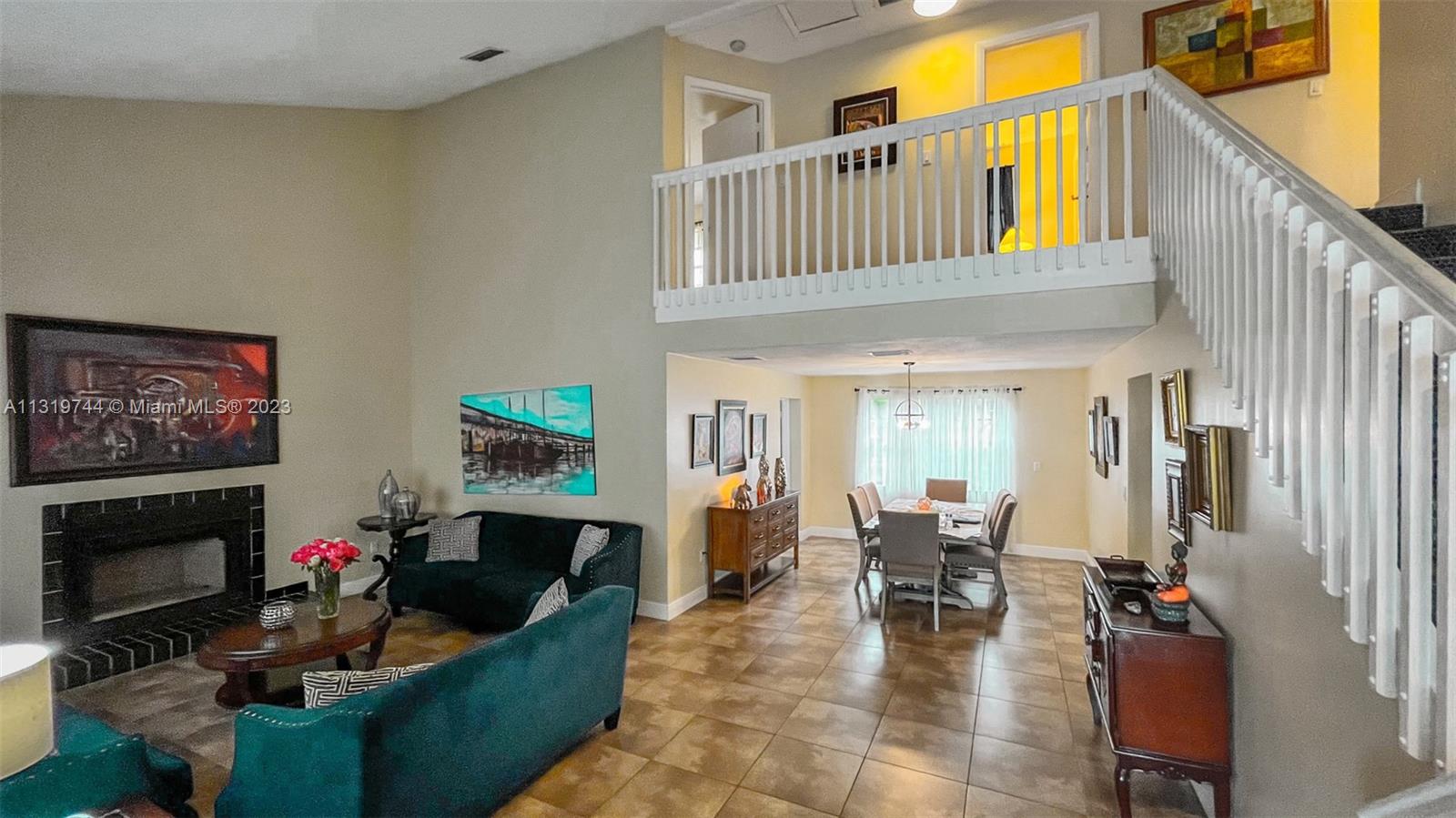 11990 Southwest 92nd Street Miami, FL 33186 - Photo 7 of 33 a living room with furniture a fireplace and a flat screen tv