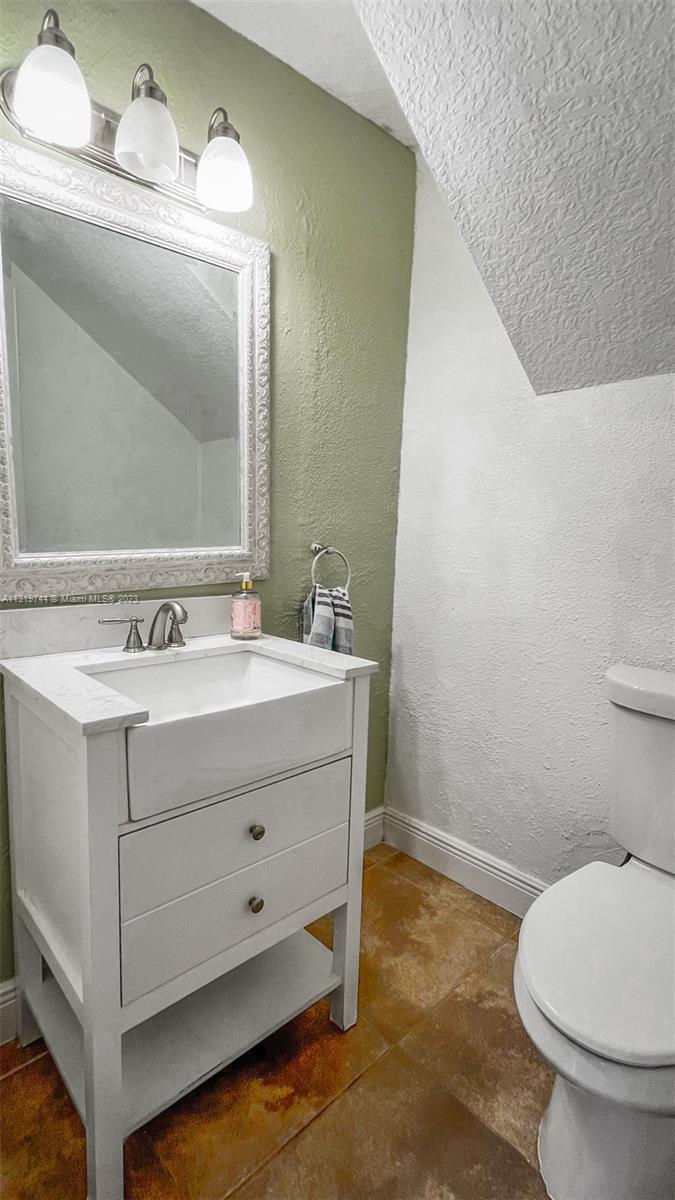 11990 Southwest 92nd Street Miami, FL 33186 - Photo 9 of 33 a bathroom with a sink mirror vanity and toilet