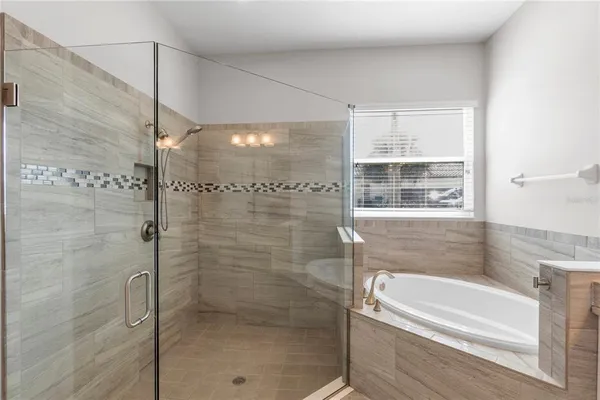 a bathroom with a bathtub and a shower