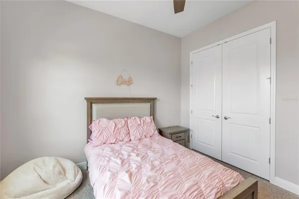 a bedroom with a bed and a lamp