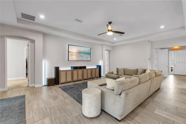 a living room with furniture and a chandelier
