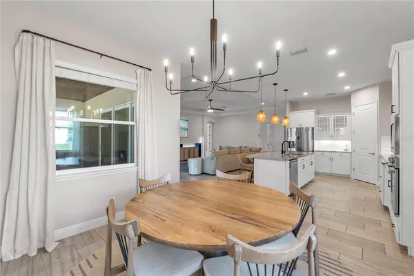 a large kitchen with cabinets table and chairs
