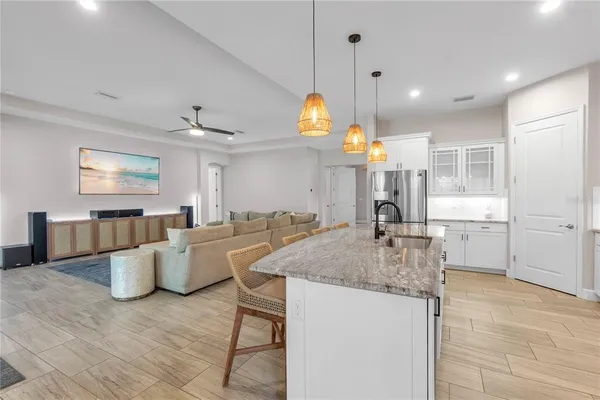 a kitchen with a stove a sink cabinets and wooden floor