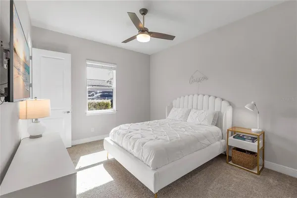 a bedroom with a bed and a large mirror