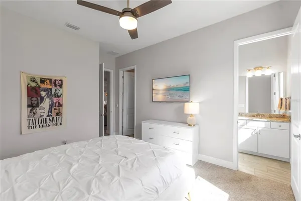 a bedroom with a bed and a large mirror