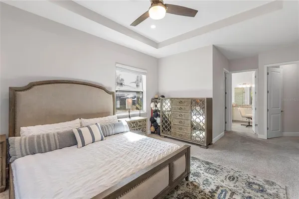 a bedroom with a bed a mirror and a table