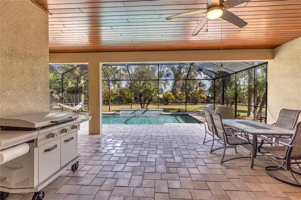 a view of a porch with chairs and backyard
