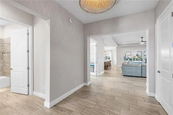 a spacious bathroom with a shower a sink and a mirror