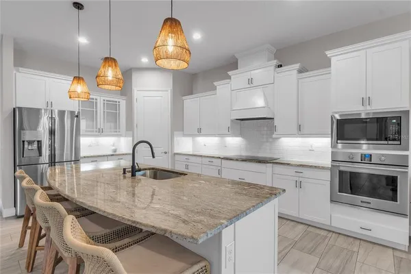 a kitchen with stainless steel appliances granite countertop a sink counter space and cabinets