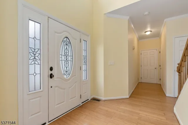 a view of front door with wooden floor