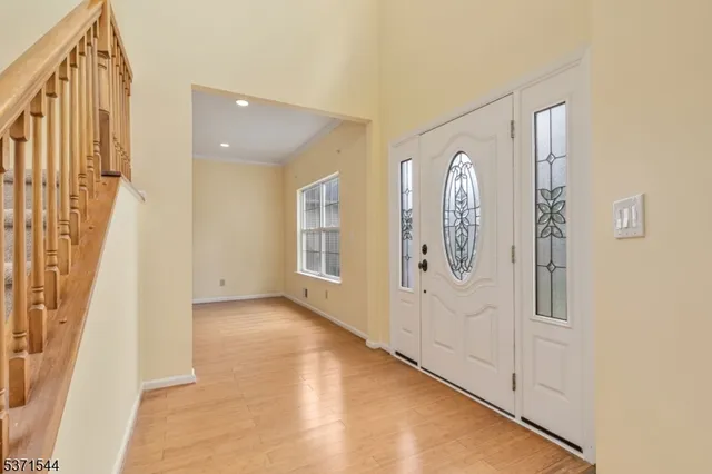 a view of a hallway with windows and entryway