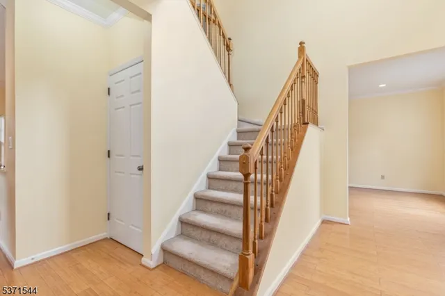 a view of staircase with white walls and railing