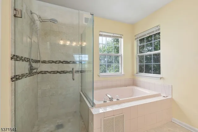 a bathroom with a tub sink and shower