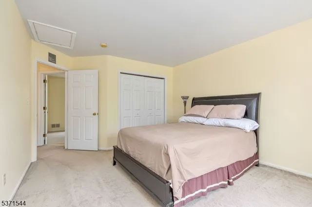 a bedroom with a bed and a painting