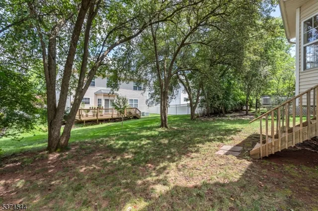 a view of house with backyard and tree