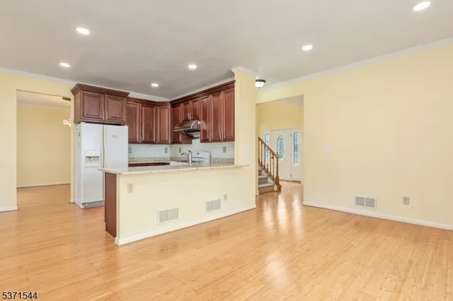 a view of kitchen with appliances cabinets and furniture
