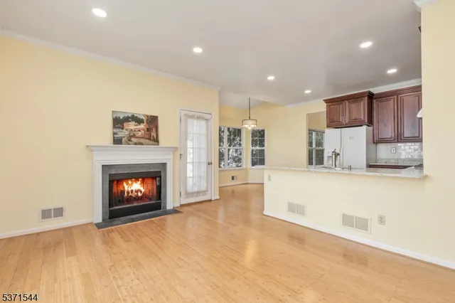 a view of kitchen with fireplace and wooden floor