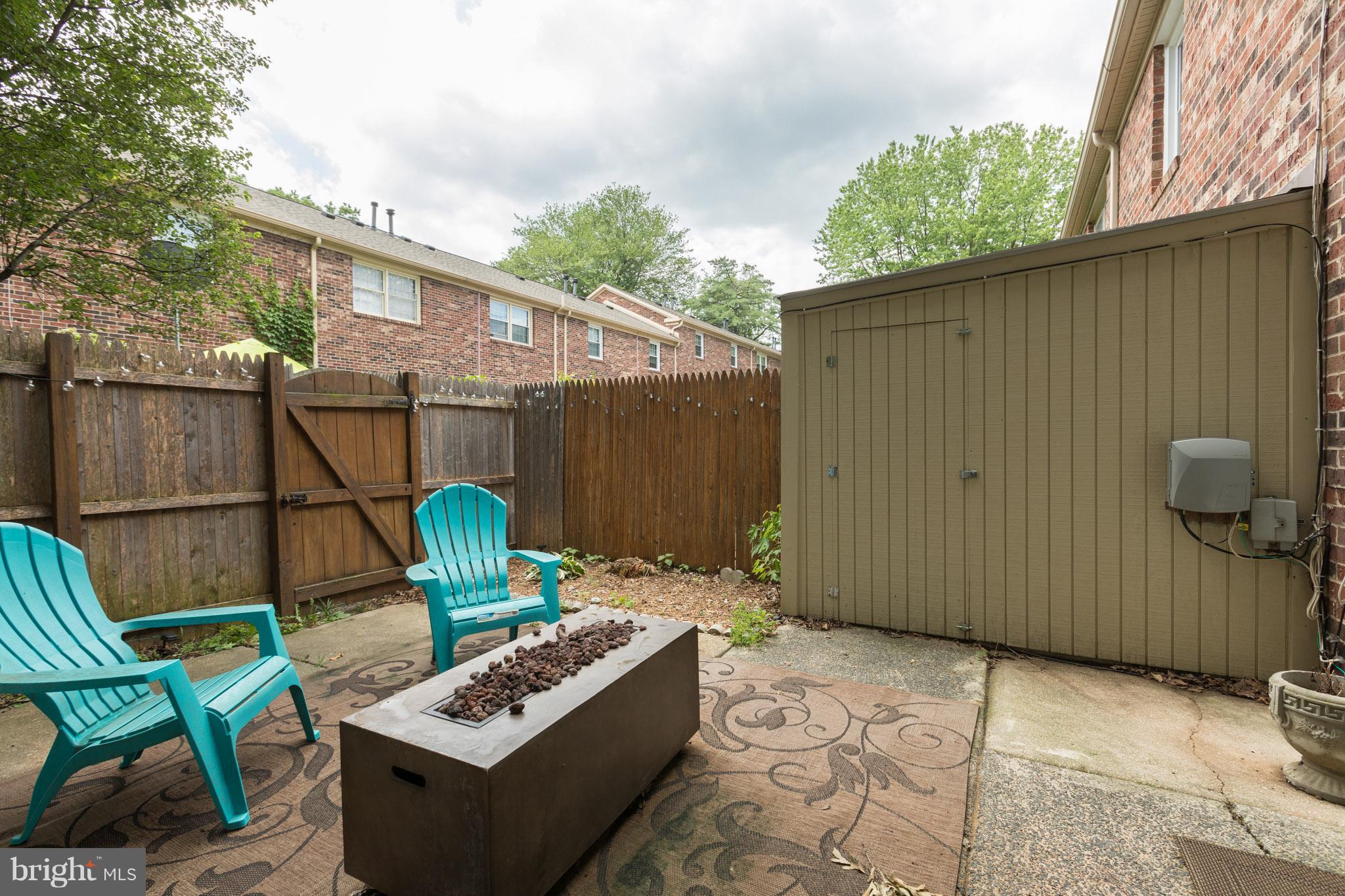 8355 Dunham Court, Unit 607 Springfield, VA 22152 - Photo 14 of 15 a backyard of a house with outdoor seating
