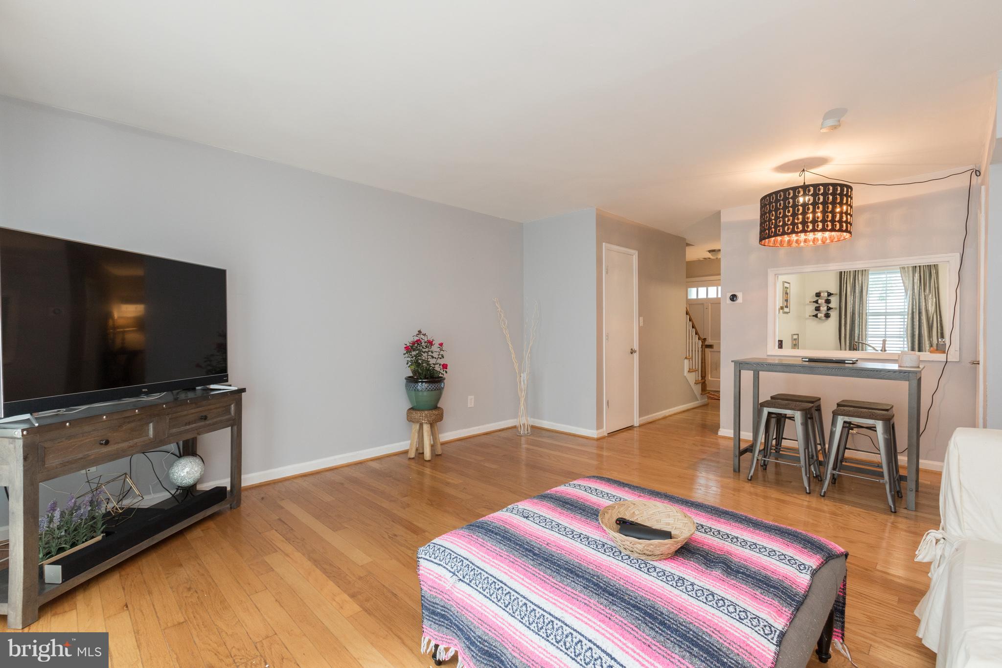 8355 Dunham Court, Unit 607 Springfield, VA 22152 - Photo 3 of 15 a bedroom with furniture and a flat screen tv