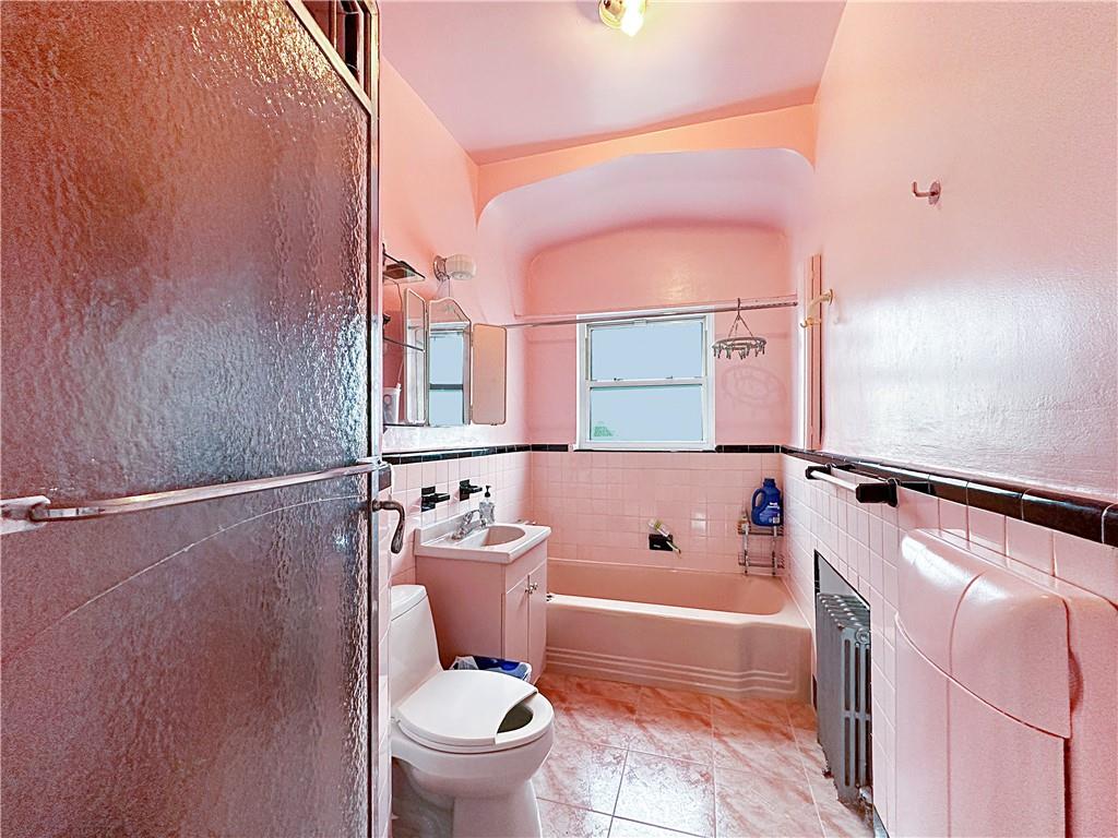 18 Corbin Place Brooklyn, NY 11235 - Photo 12 of 22 a bathroom with a bathtub shower sink mirror and toilet